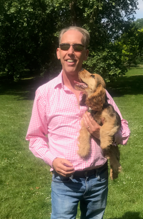 Bradley smiling with a dog