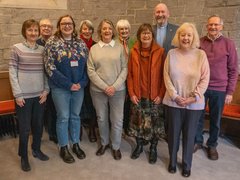 Group of people stood smiling