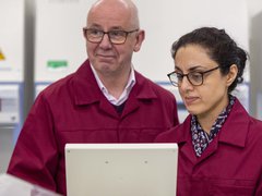 Professor Chris Bunce and Dr Farhat Latif Khanim look at a screen together in a research lab.