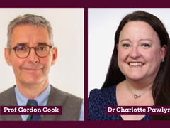 Headshots of a man and woman side by side smiling. The man has grey hair and glasses and the woman brown hair.