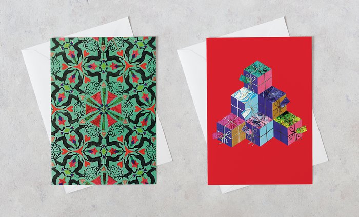Two christmas cards sit side by side with festive, abstract patterns on each