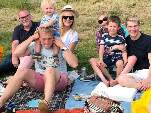 Charlotte and her family having a picnic in a field after she became very ill