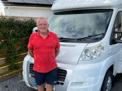 Craig, who is living with myeloma, standing in front of his motor home