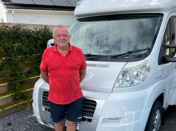 Craig, who is living with myeloma, standing in front of his motor home