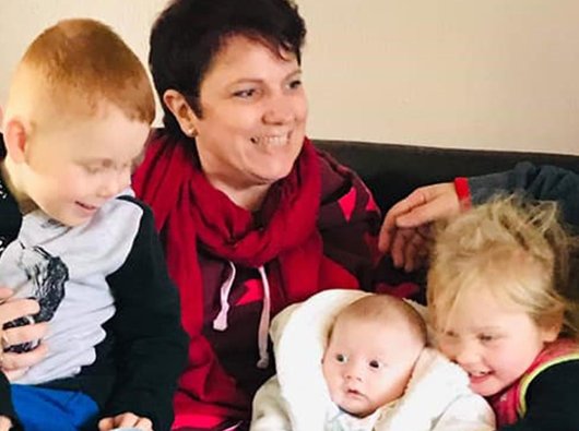 Donna, who's being treated for follicular lymphoma, with her family of three children.
