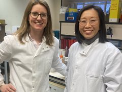 Dr Tracey Chan and Dr Jen Heaney stood in the lab together smiling.