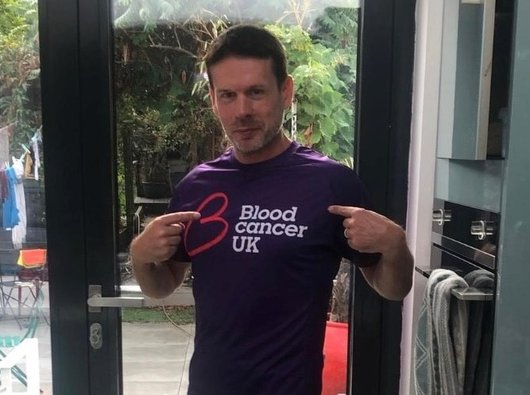 Ed, who is living with ET, wearing a Blood Cancer UK to go on a training run