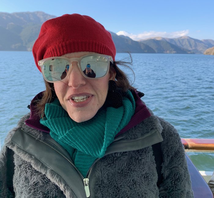 Esther, who is living with essential thrombocythaemia (ET), on a boat trip through mountainous scenery
