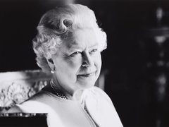 A black and white portrait of Her Royal Majesty Queen Elizabeth II, smiling and peaceful