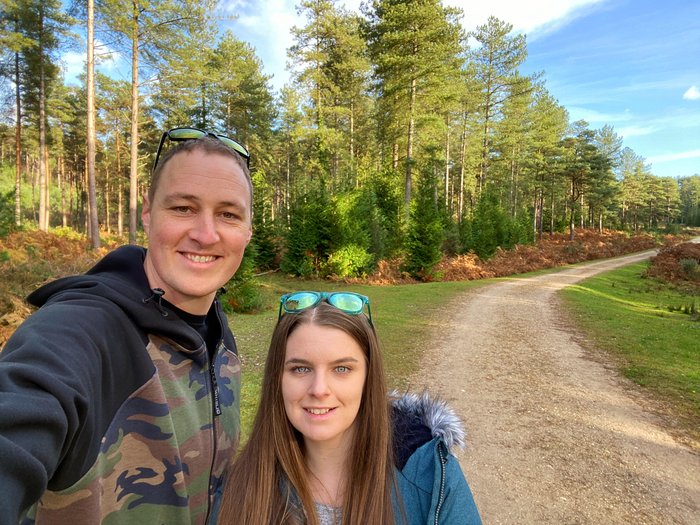 Grant, who had CAR T-cell therapy for blood cancer, standing next to his wife. They're outside in the countryside, with trees behind them.