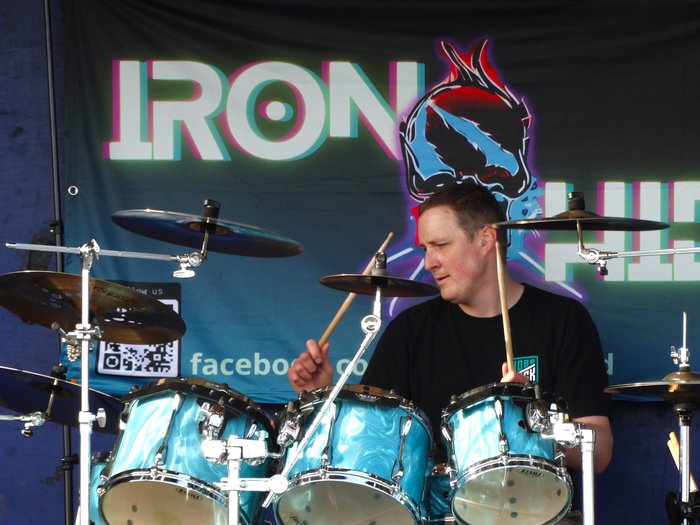 Grant playing the drums on stage