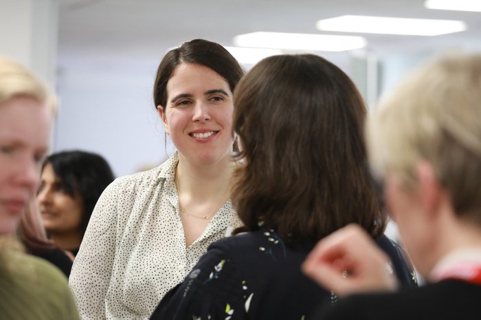 Steph Cullen, former Blood Cancer UK employee, at a networking event with blurred people in the background.