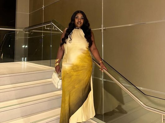 Mphango, who had has treatment for acute myeloid leukaemia (AML), dressed smartly, standing on a staircase.