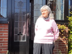 Jill, blood cancer patient, stood outside her house in the sun.