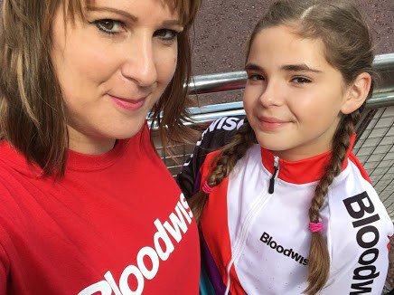 A woman and child taking a selfie and smiling, wearing Bloodwise branding t-shirts.