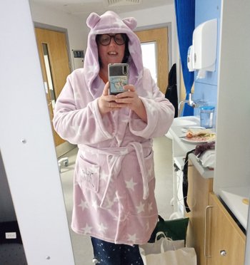 Louise, in hospital for a stem cell transplant, wearing her new dressing gown with ears.