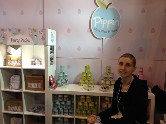 Louise MacLeod working in her family shop, with products behind her in the background.