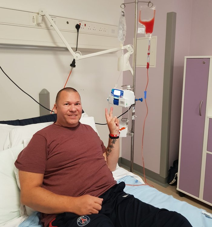 Mart in hospital, on a drip, looking cheerful