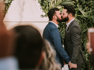 Two men kissing on their wedding day.