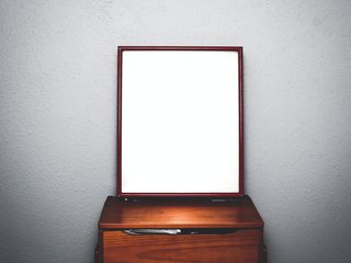 Image of a mirror standing on a dressing table.