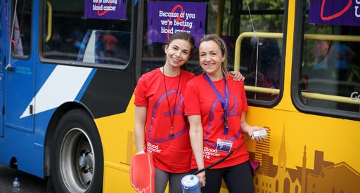Two volunteers infront of a bus at the Great North Run