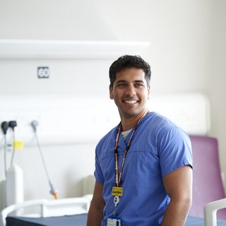 An image of a nurse in uniform working at a hospital.