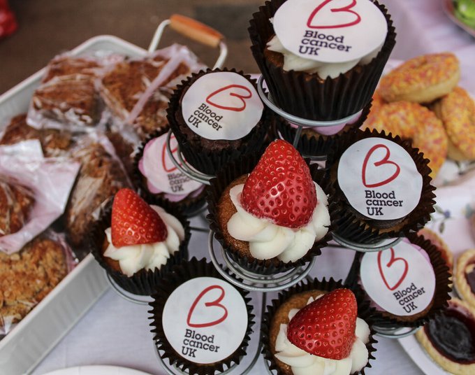 Blood Cancer UK themed cupcakes on display at a brunch or bake sale.