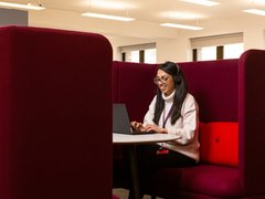 Tanya, a support worker, taking a call on the helpline in a private booth.