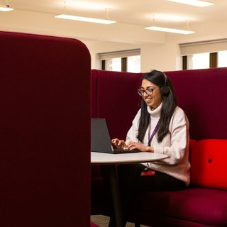 Tanya, a support worker, taking a call on the helpline in a private booth.