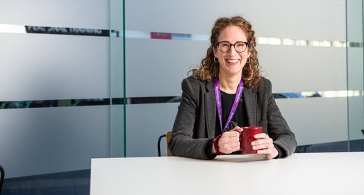 Helen Rowntree smiling and holding a cup of coffee.