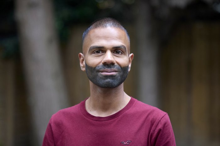Headshot of Sunny, a person affected by blood cancer, smiling at the camera.
