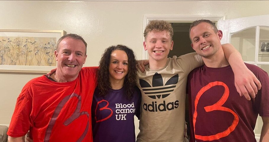 A family proudly wearing Blood Cancer UK t-shirts, smiling.