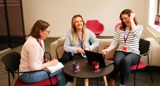 Our support services nurses sitting in the Blood Cancer UK London office, smiling and talking.