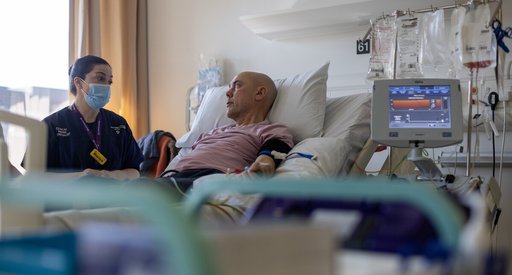 Nurse with a person in a hopsital bed