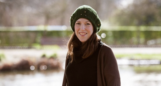 Katie, who was diagnosed with chronic myeloid leukaemia (CML), standing outside wearing a hat smiling at the camera with a blurred background.