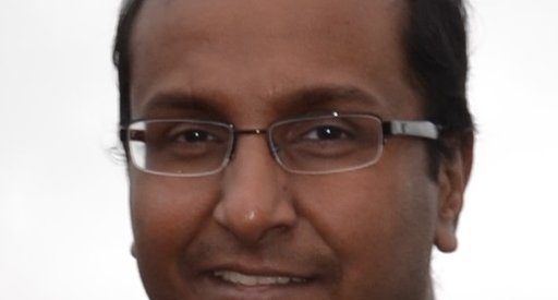 A man, wearing glasses, in a head shot.