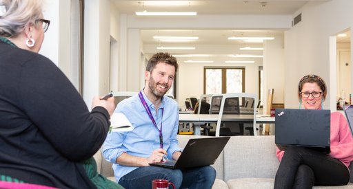 Blood Cancer UK staff looking happy in an informal meeting.