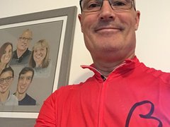 Steven, who was diagnosed with myeloma, smiling at the camera wearing his Blood Cancer UK cycling jersey.