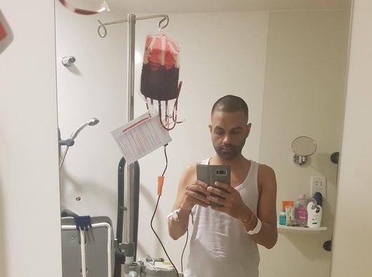 A man named Sunny takes a selfie as he received treatment via a drip in hospital.