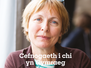 An image of the front cover of our Welsh flyer. On the front cover, there is a photo of a woman looking into the camera with a gentle smile, and the words "Cefnogaeth i chi yn Gymraeg" which means "Support for you in Welsh"