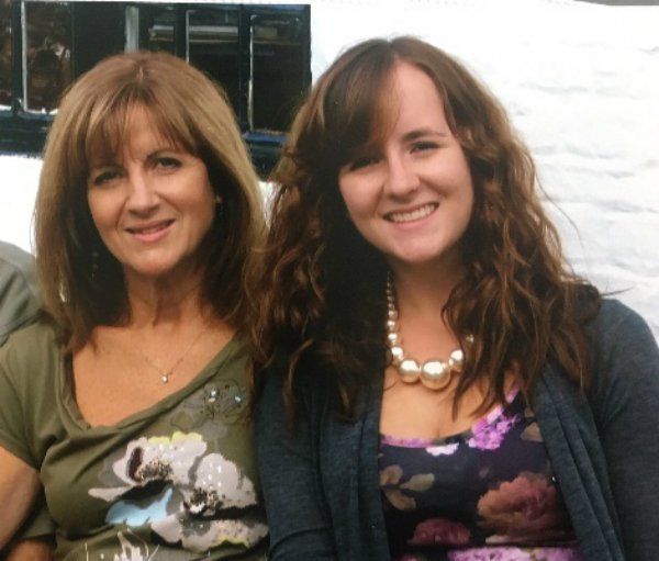 Two women - Amy and her mum - pose for a photograph