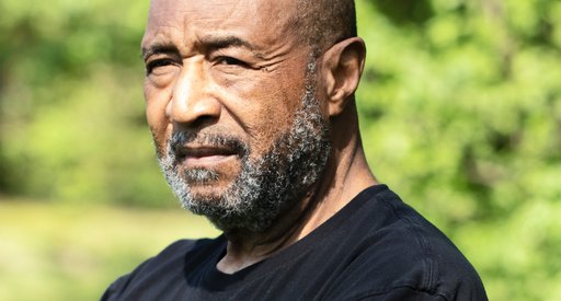 An older Black man looks thoughtful after his diagnosis