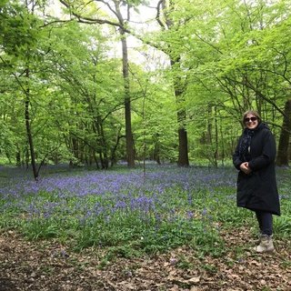 Rachel stands in a forest
