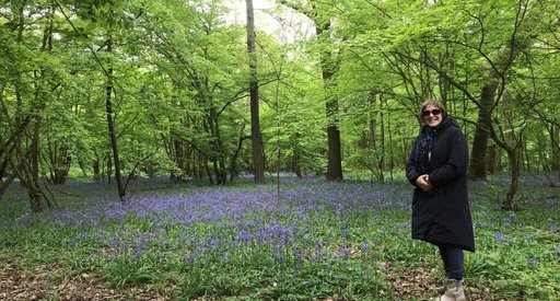 Rachel stands in a forest