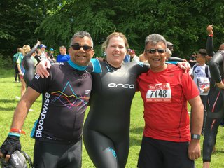 Three participants post at a triathlon together.