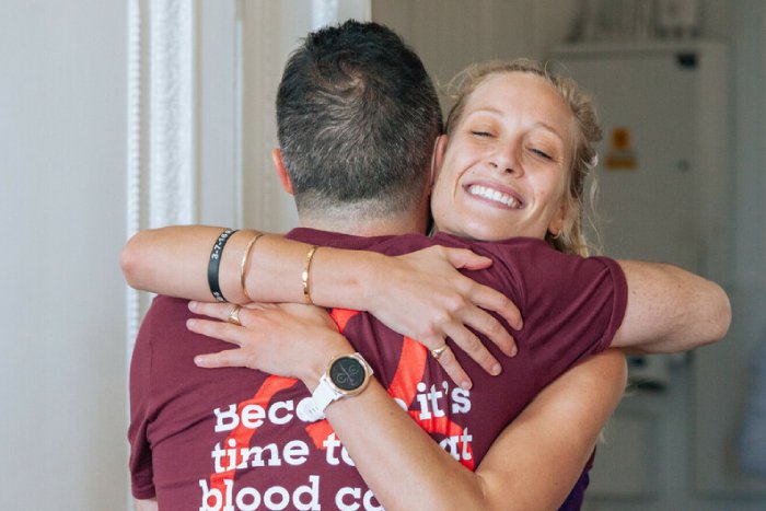 Two Blood Cancer supporters hug at the London marathon race reception