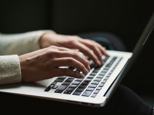 a person typing on a laptop