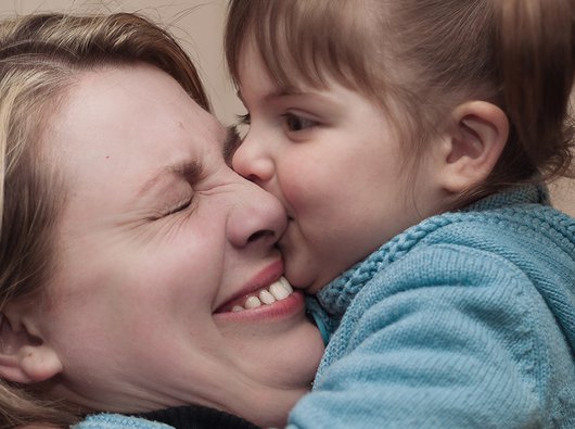 A mother hugs her child