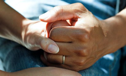 A close up of two people holding hands