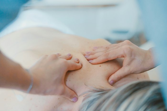 Someone having their back massaged in a spa